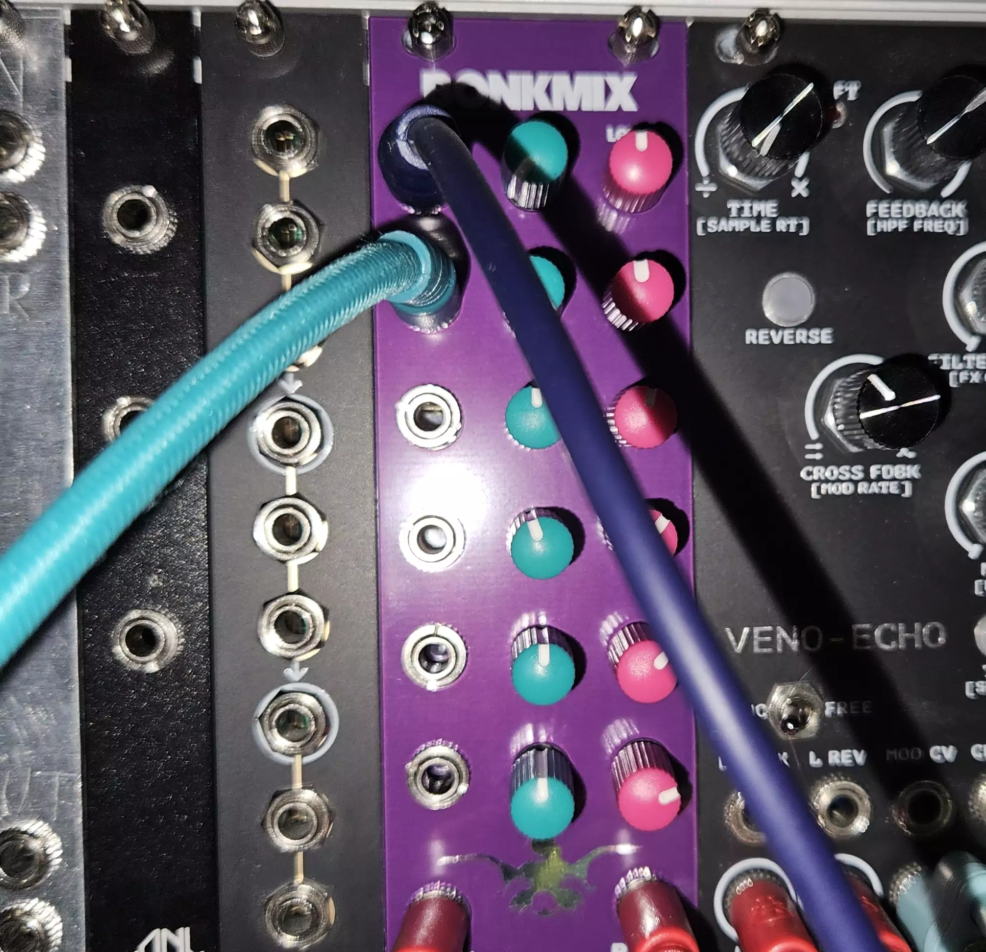 The Bonkmix module placed between other modules with cables patched into it.