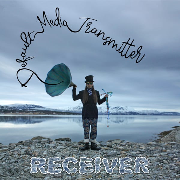 A weirdly dressed weirdo standing by the sea in a fjord. He's holding a patch cable bouquet and a huge gramophone horn. 