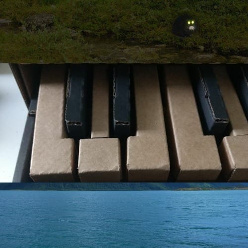 Album cover featuring a cardboard keyboard, some greenery, and the sea